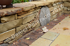 Sandtone-Seating-Wall-with-Millstone-Autumn-2015-afternoon