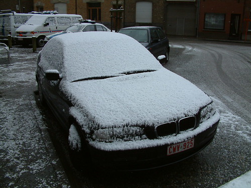 Black BMW 320d wearing a thin layer of white snow