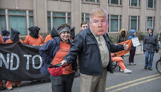 Chantal de Alcuaz and Witness Against Torture are Joined by a Man in a Mask Outside the Presidential Inauguration of Donald Trump