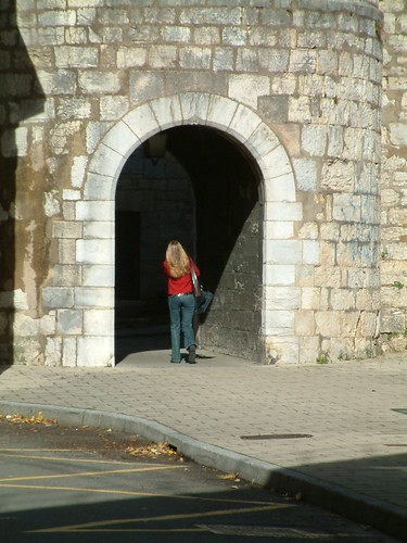 Girl walking through arch