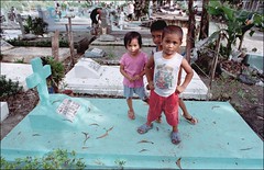 Three Children Standing on Grave