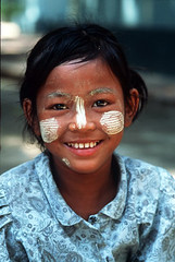 Girl wearing tanaka, a sandalwood paste to protect her from the sun - Mandalay, Burma