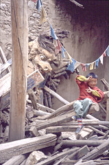 Young Tibetan inside a destroyed Buddhist temple, Tibet