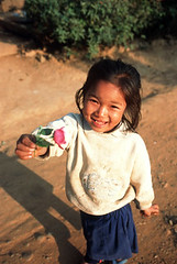 Girl giving flower as a gift - Laos