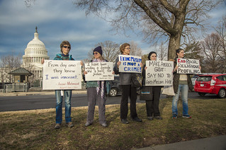 Protesters Holds Signs Outside the Ziglar v. Abbasi Hearing at the U.S. Supreme Court