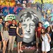 NC State Public History in Prague students and faculty pose at the John Lennon Wall, the site of a clash between authorities and students during the late Communist Era, and now a pilgrimage site for peace activists and backpackers.